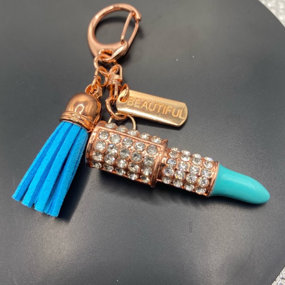 Light blue lipstick rose gold tone with a tag with beautiful keychains